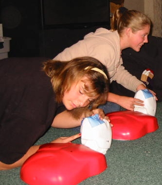 Students practicing CPR with training manikins